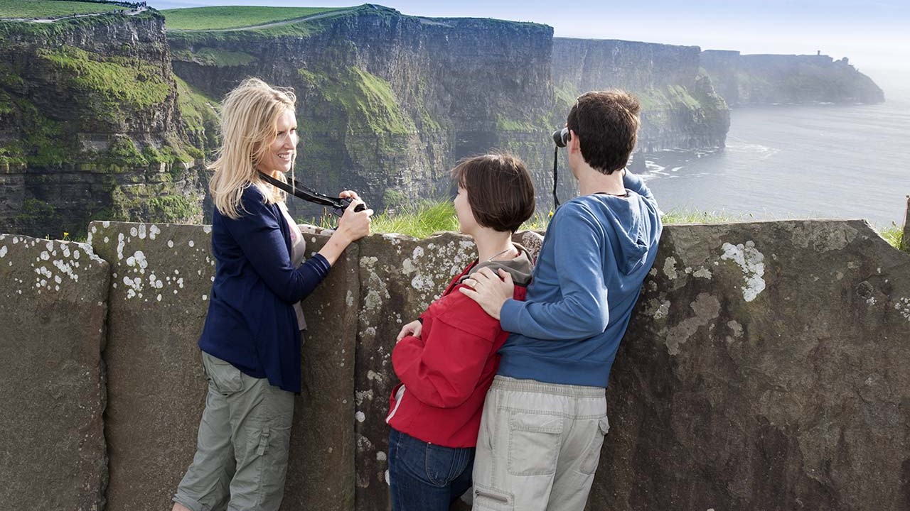 People on a cliff overlook in Ireland.